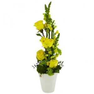 Tjusig, hög blomsterdekoration med gula blommor. Beställ hos Florister i Sverige!
