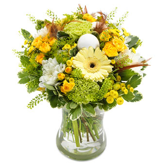 Påskbukett med blandade blommor i gult, orange, grönt och vitt tillsammans med gröna blad. Skicka med blombud via Euroflorist!