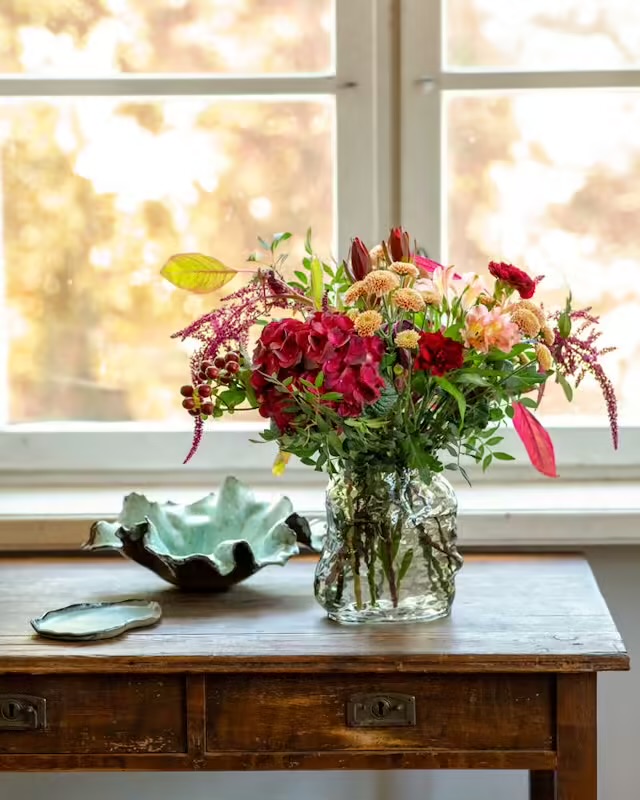 Gör någon glad med Interfloras septemberbukett! Vacker bukett med bland annat alstroemeria, nejlika, krysantemum och andra snittblommor. Välj mellan tre storlekar på buketten. Den största innehåller även en hortensia.